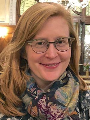 Ellery Foutch wearing large patterned scarf and blazer