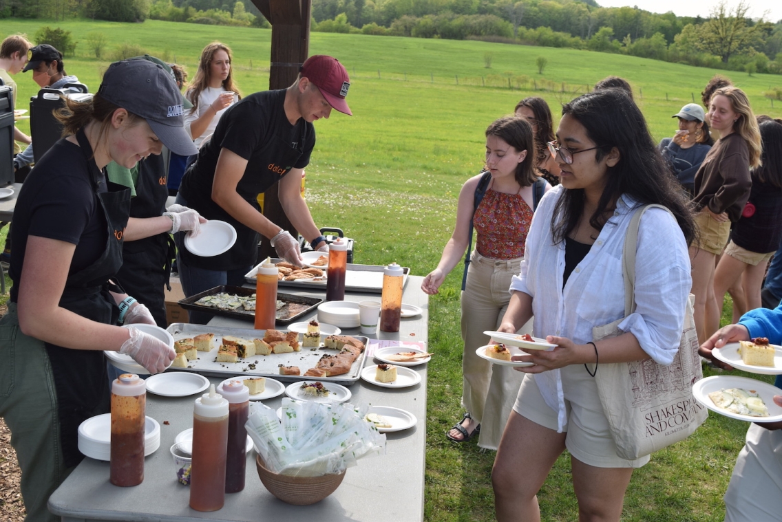 Students gather at the knoll to enjoy a meal prepared by Doci.