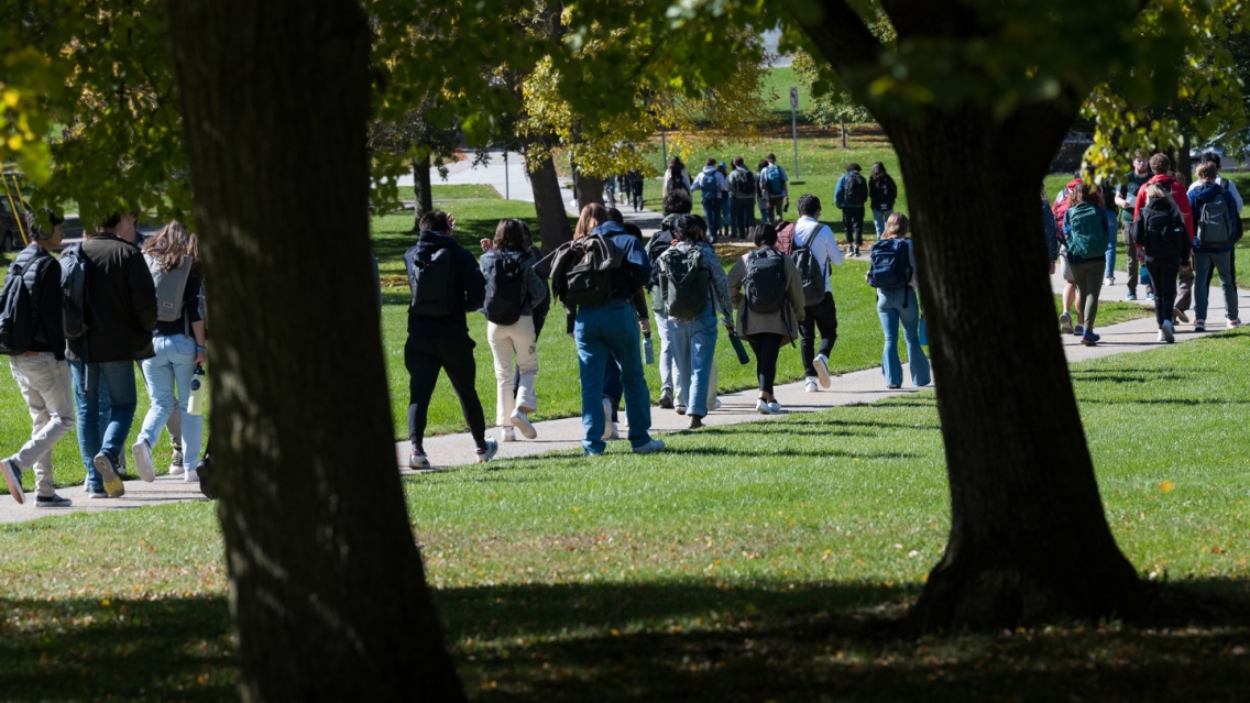 Students walking through campus on a sunny day.