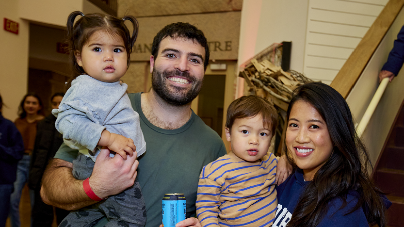 A family with two young kids smile at the Homecoming Harvest Fest