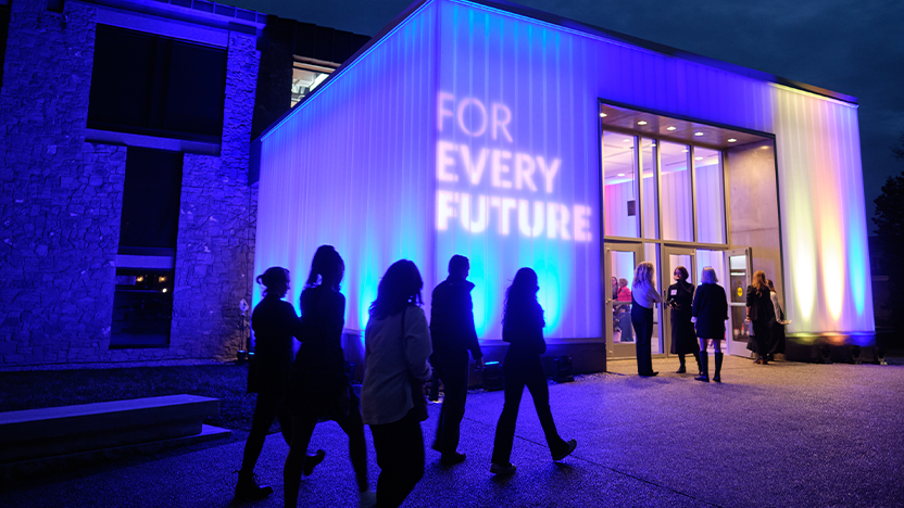 The renovated Christian Johnson building lit up in blues, greens, yellows, and red to celebrate the launch of For Every Future.