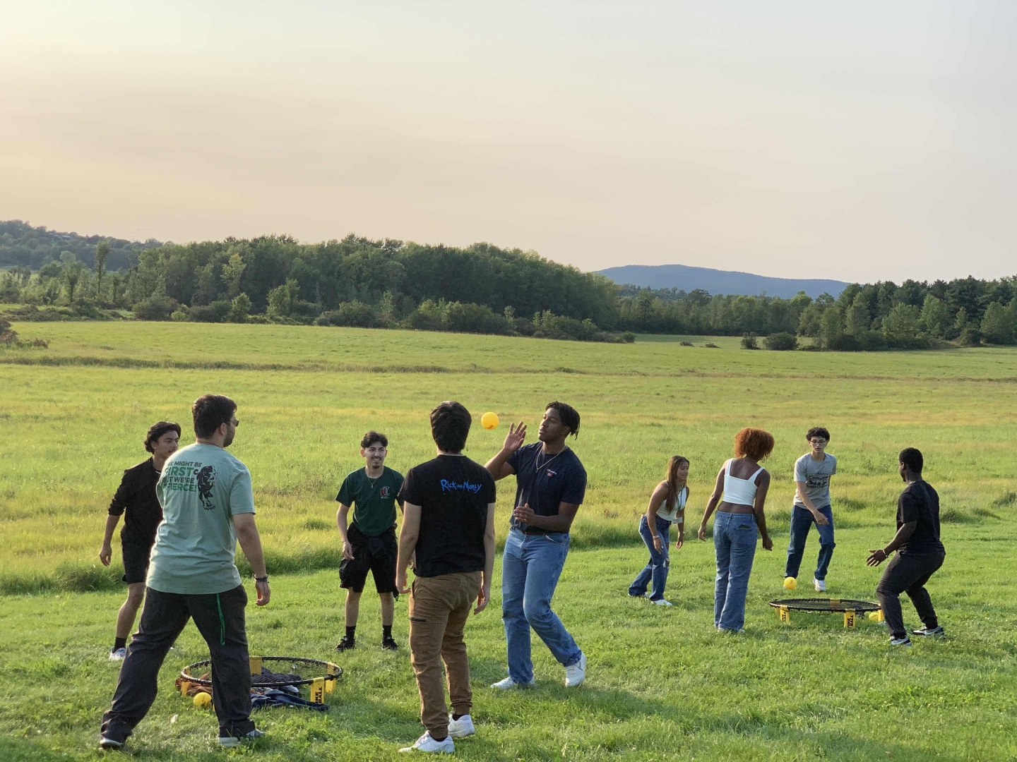 A group of students playing outdoor games in a field.