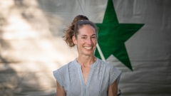 Portrait of Rachel Schiffer ’06.5 in front of a circus tent with a green star.