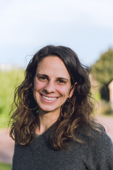 Smiling woman with wavy brunette hair