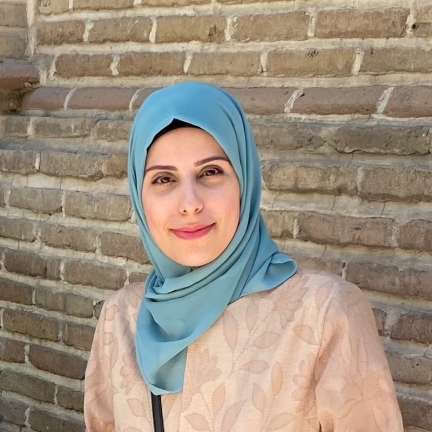smiling woman in light blue hijab
