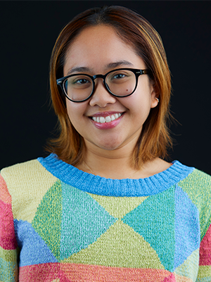 Amina Matavia in multicolored blocks knit sweater