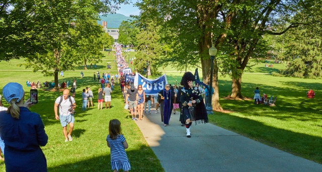 class parade up Storrs Walk, led by President Patton and bagpiper