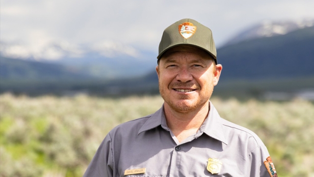 Portrait of Dan Stahler ’09 wearing his park ranger uniform
