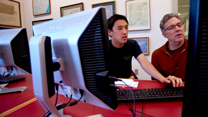 A student works with a GIS professor in the computer science center.