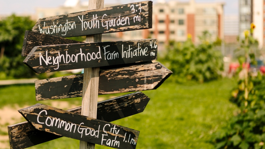 A signpost directing to the various community gardens student volunteers have helped create in food-insecure neighborhoods.