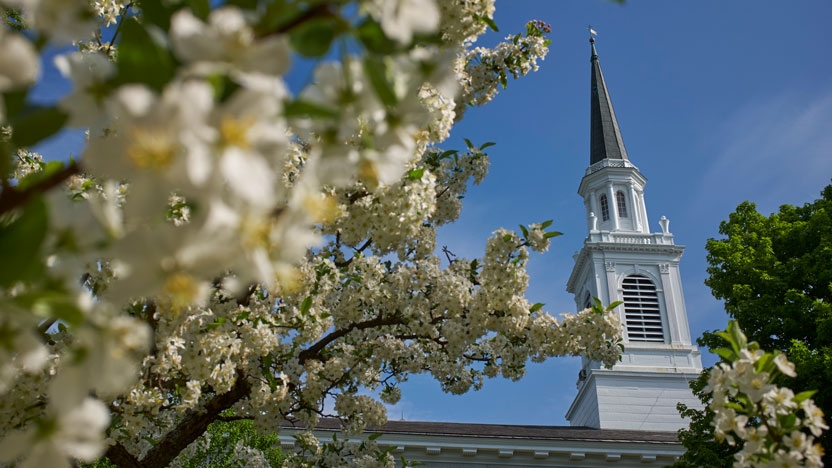 A view of Middlebury Chapel with spring blooms in the foreground.