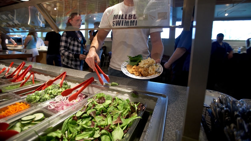 A student serves himself from the salad bar in Ross Dining Hall.