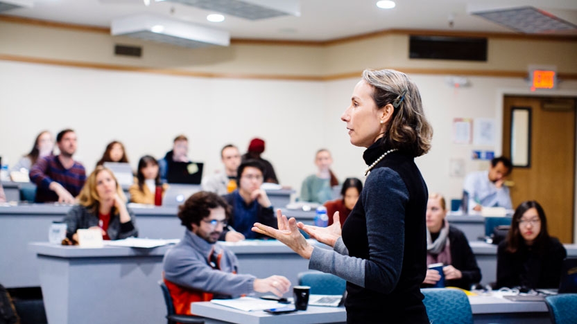 A professor speaks to her class.