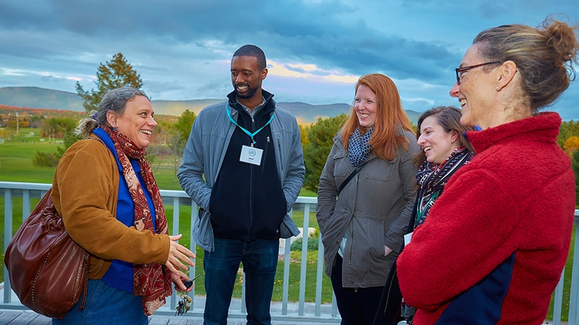 President Laurie Patton, students, and staff talk outdoors.
