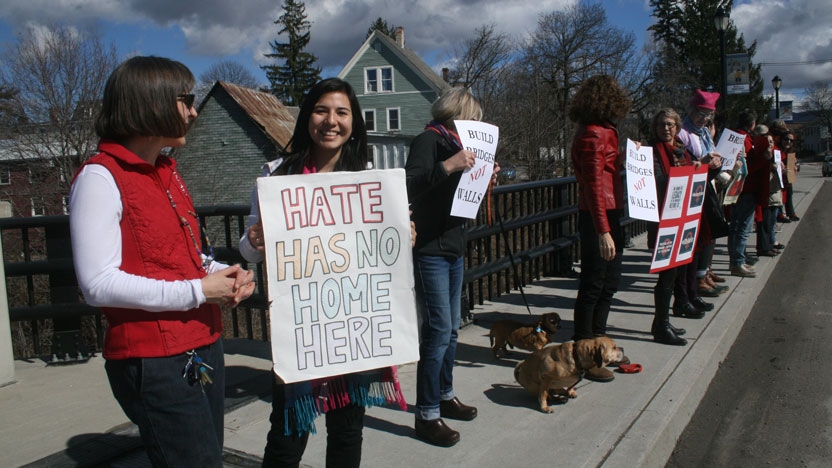 Participants gather on the Middlebury Cross Town Bridge for International Women's Day.