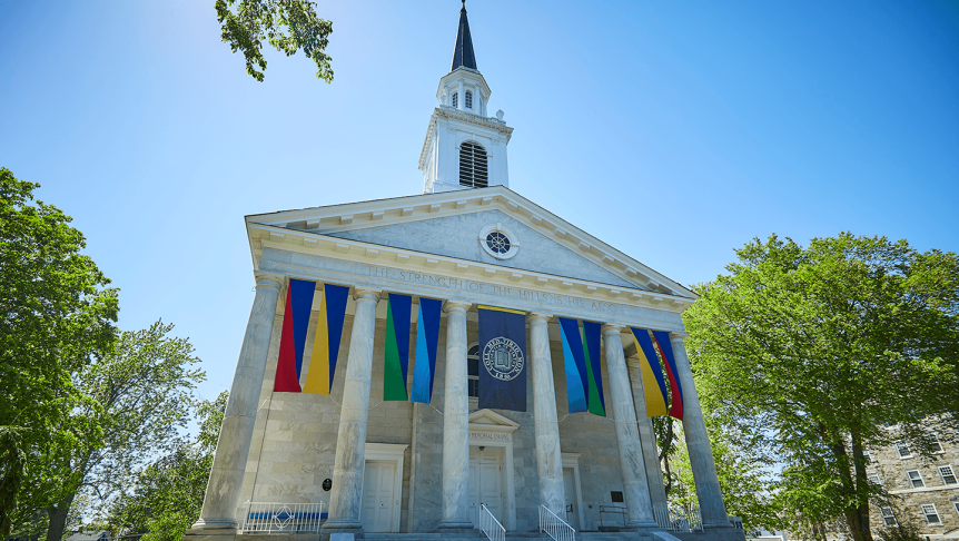 Middlebury Chapel on a sunny summer day, colorful banners waving