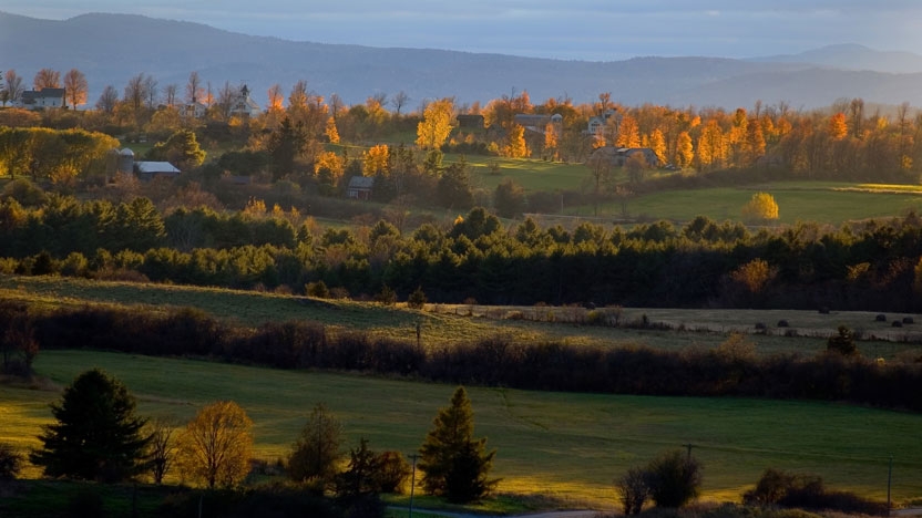 View of the Middlebury campus and Green Mountains at sunrise.