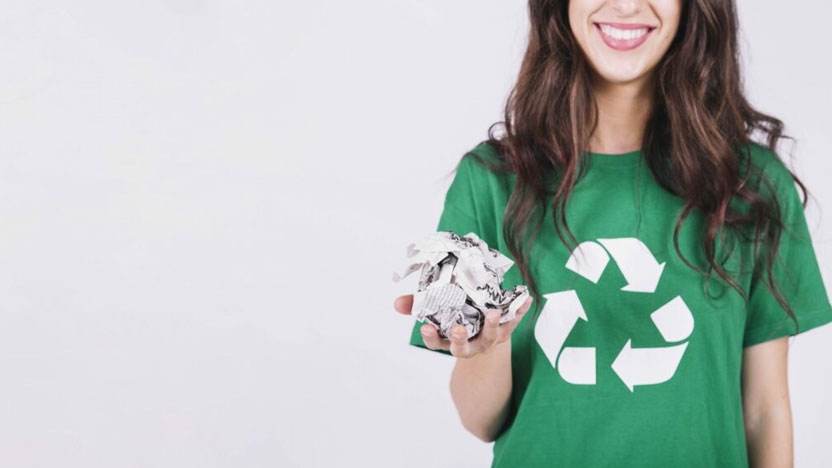 A student poses in a recycling t-shirt to promote paper recycling.