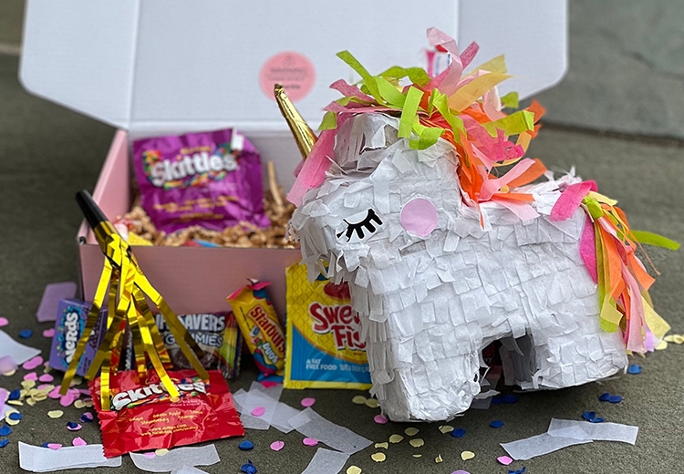 Unicorn Piñata surrounded by candy