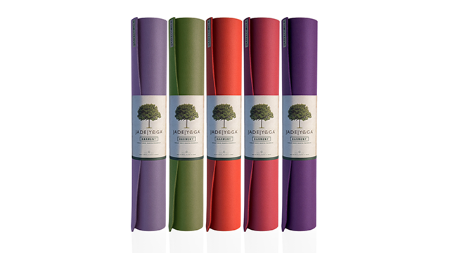 a variety of rolled up yoga mats, each with a label saying "Jade Yoga"
