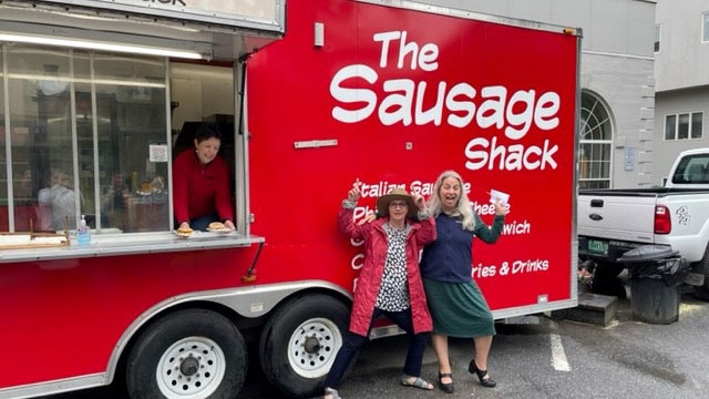 Employees enjoying breakfast sandwiches at the Sausage Shack.