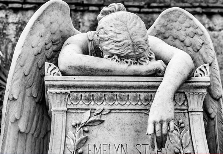 Black and White photo of a statue of an angel weeping into their arms