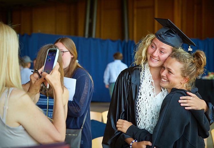 A graduate embraces their relative at the WLAX graduation 2023 celebration