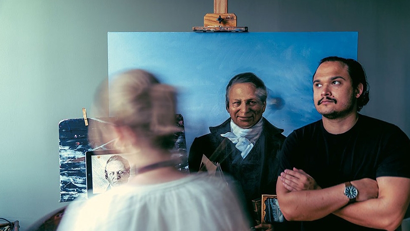 Katie Runde painting Twilight's Statehouse portrait while Demetrius Borge poses.