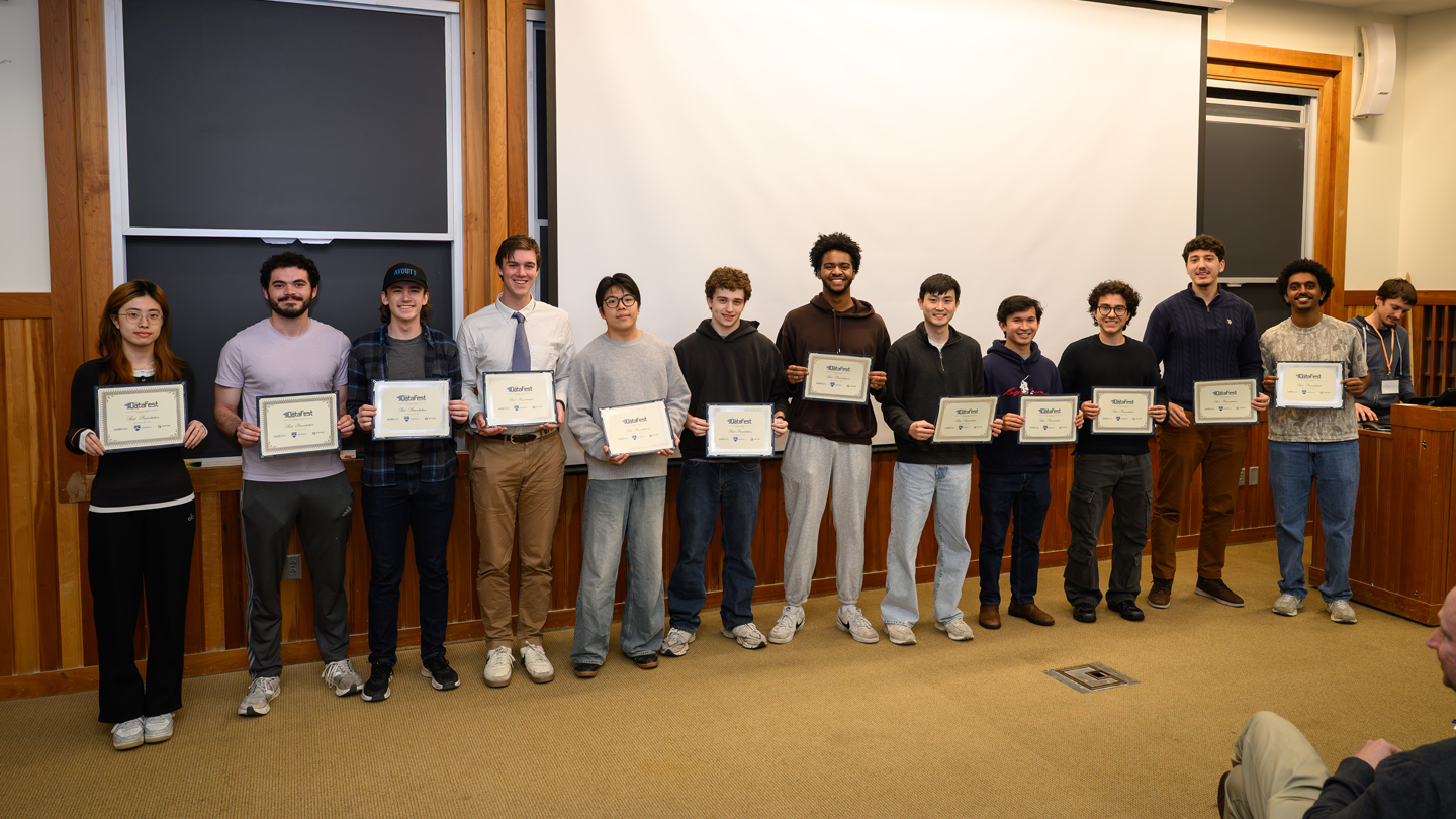 A row of students holds up their winning certificate after the DataFest challenge.