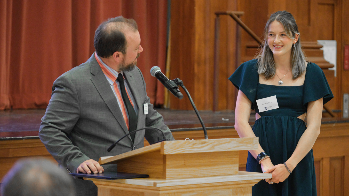 Two people pose for a photo during an awards ceremony.