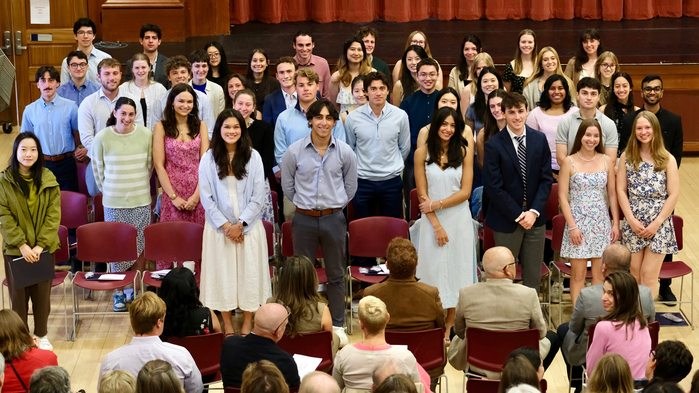 A group of students poses for a photo during a ceremony.