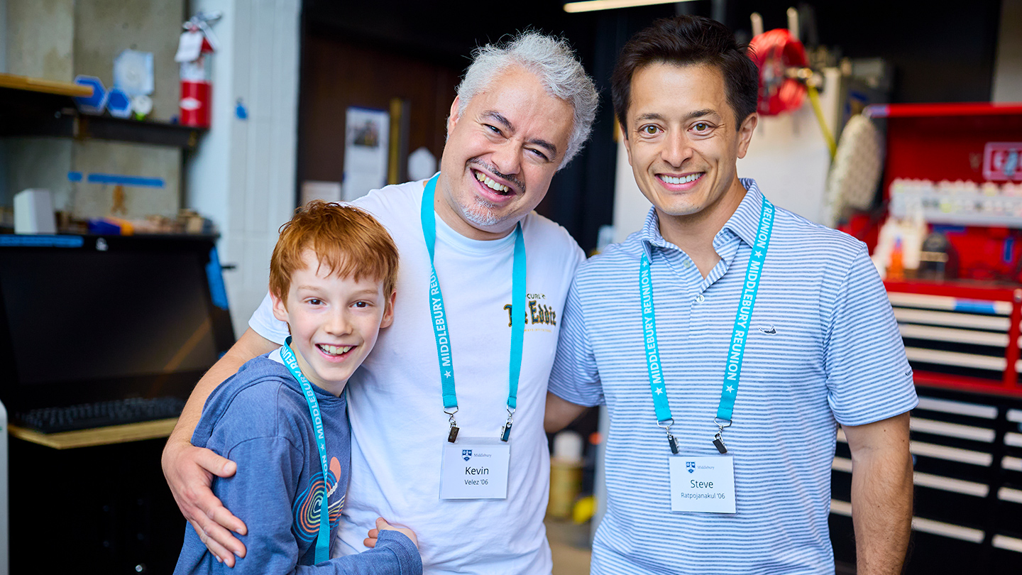 Two adults and a child smile for a photo at Reunion.