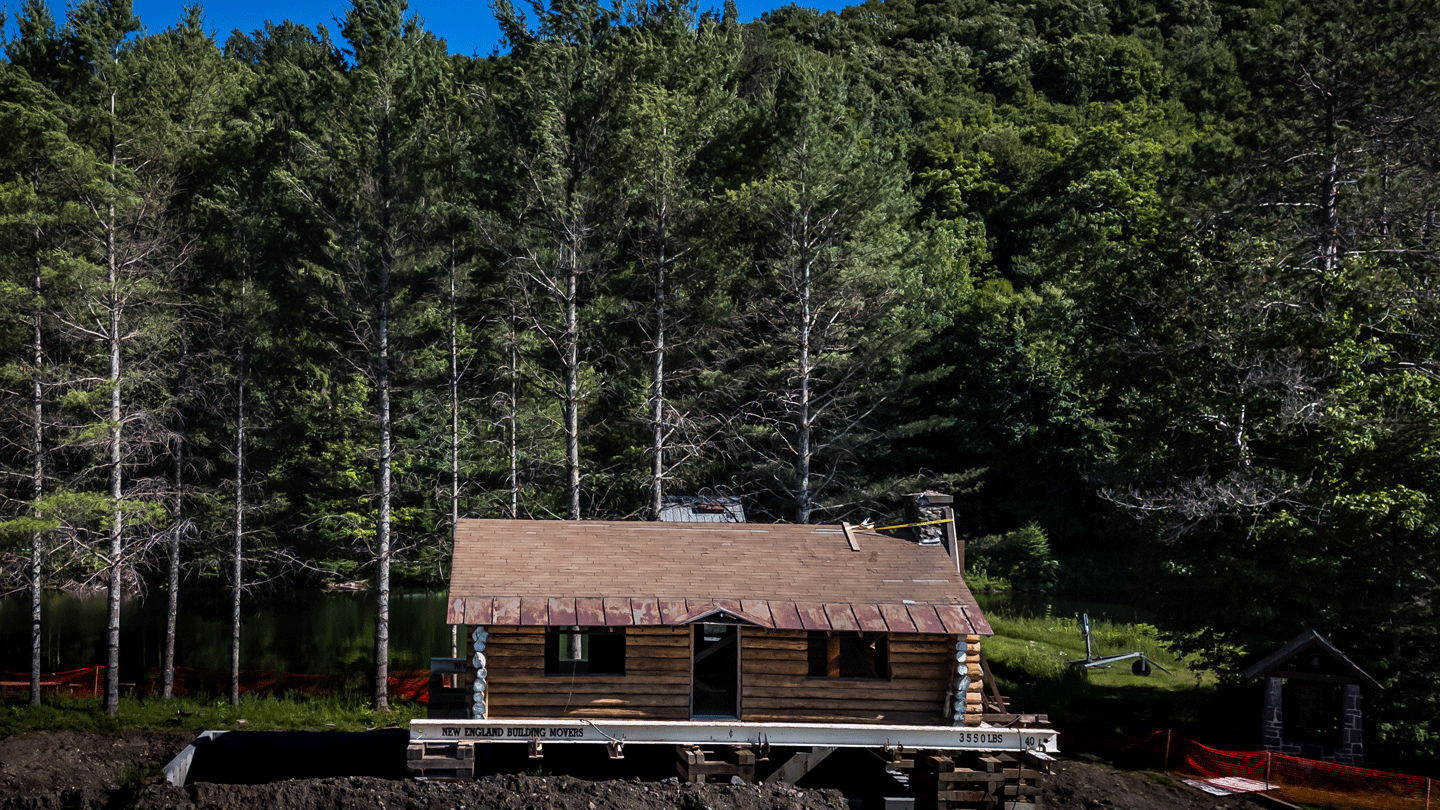 The historic Hubbard cabin at the Middlebury College Snowbowl surrounded by trees after being moved to a new location.. 