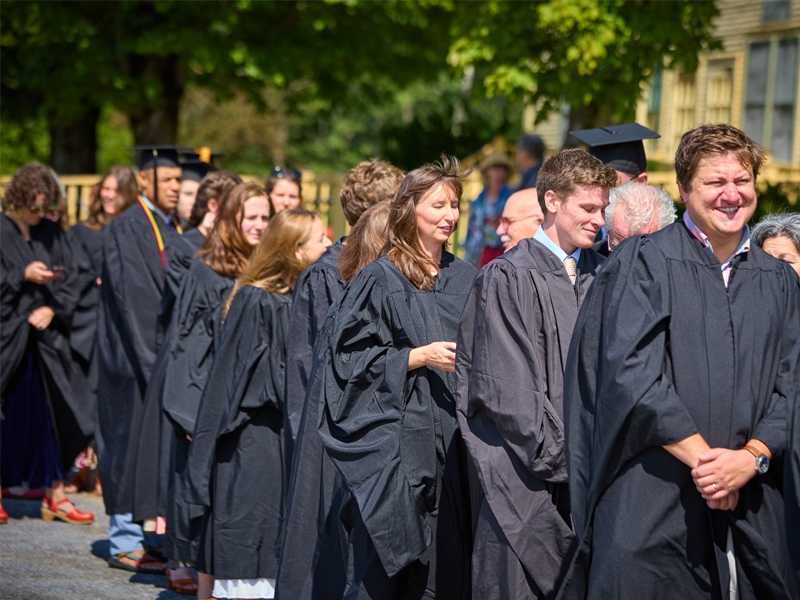 Students in academic regalia line up for the Commencement procession.