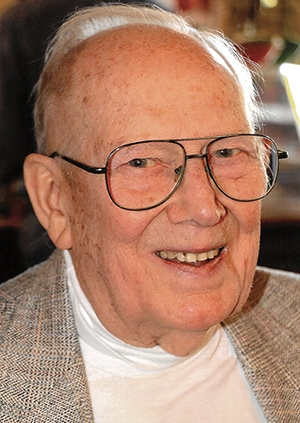 Photo of Richmond Littlefield smiling with white shirt and tan jacket