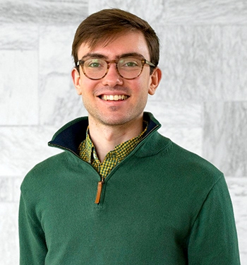 Head shot of student Brett Gilman wearing a green sweater