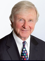 head shot of man wearing white shirt, tie, and jacket