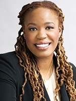 head shot of woman with white shirt and dark blazer