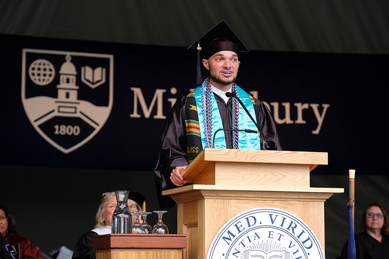 A Middlebury graduate delivers a speech during commencement.