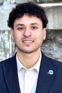Photo of student in white shirt and dark blazer.