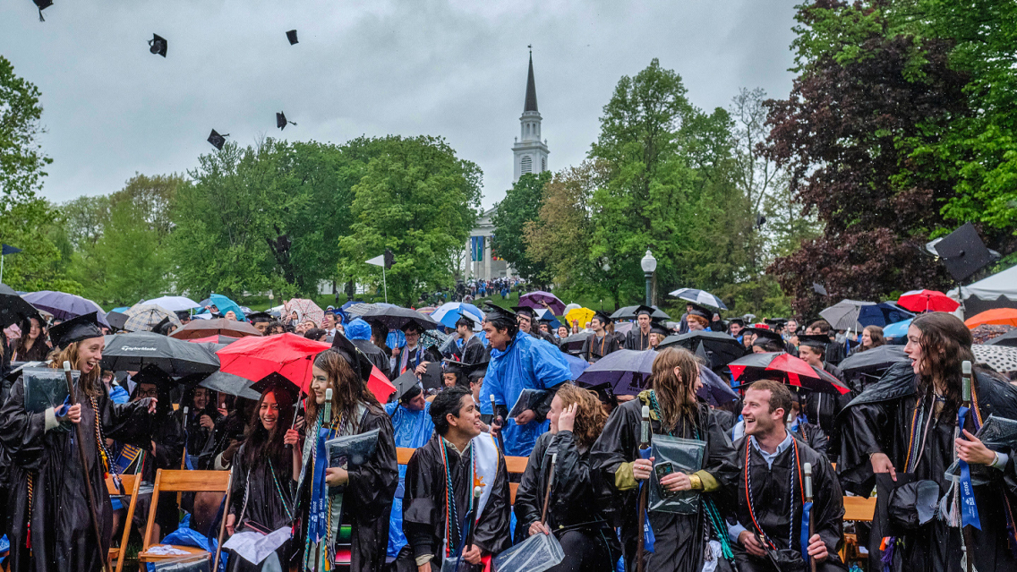 Middlebury students toss their caps in the air following Commencement.