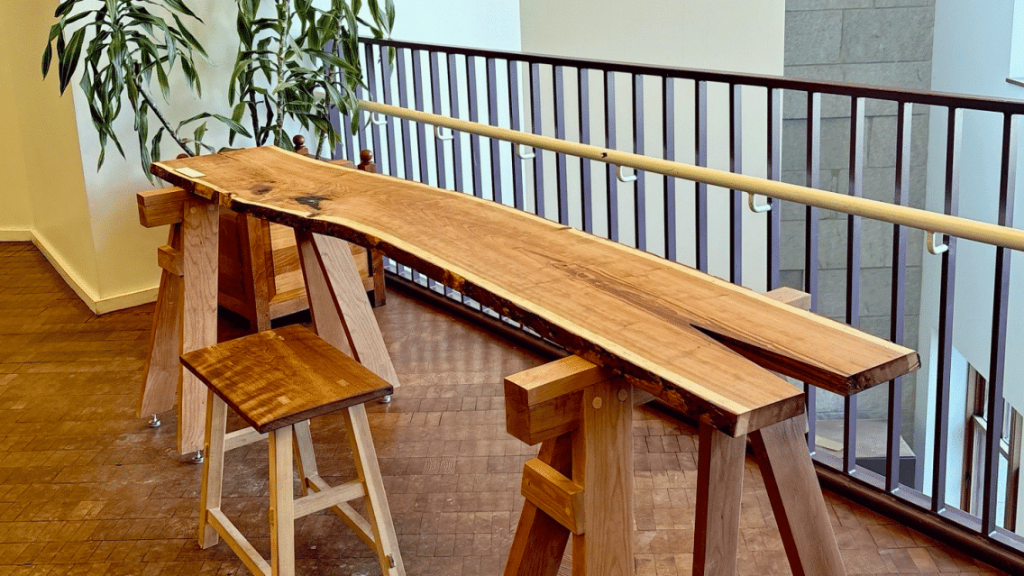 A long narrow wooden study table at the Mahaney Center for the Arts.