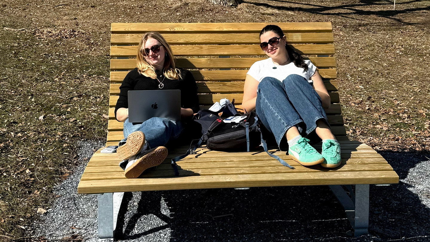 Two students sitting on a bench