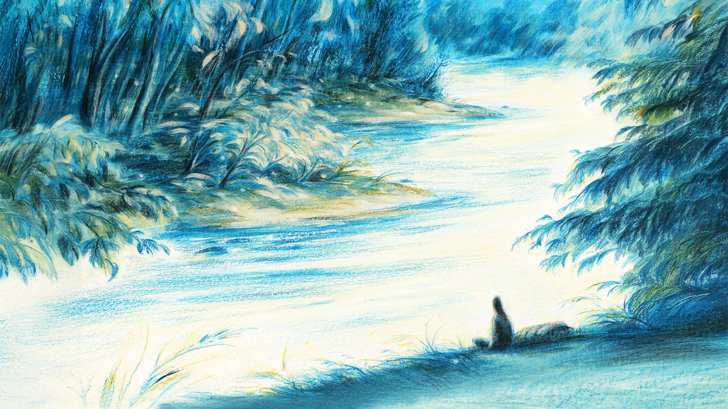 Person sitting along the banks of a flowing river