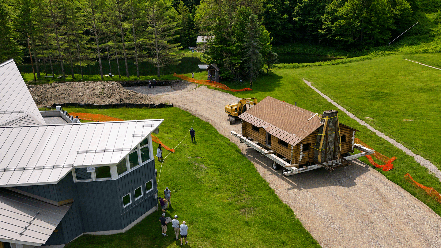 An ariel view of the historic Hubbard log cabin at the Middlebury College Snowbowl being moved to its new location near Starr Lodge.