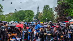 Middlebury students toss their caps in the air following Commencement.