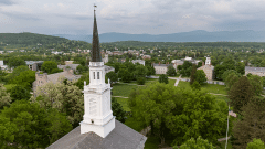 An aerial view of the Middlebury campus with a chapel spire in the foreground.