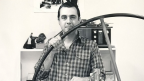Photo of art professor David Bumbeck looking at the camera in his art studio.