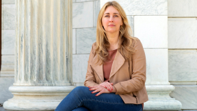 Professor Caitlin Myers sits on the steps of Middlebury chapel.