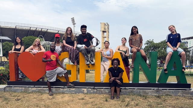 Students pose for a photo with an I Love Ghana sign.
